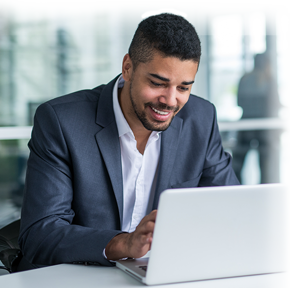 Black man typing on keyboard of a laptop computer