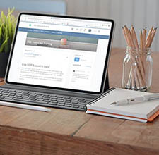 Laptop, on a table, with on-line course on the screen